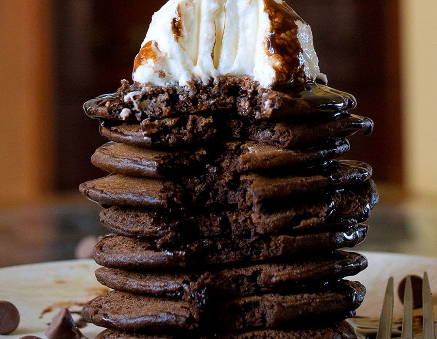 Stack of protein pancakes topped with fresh berries